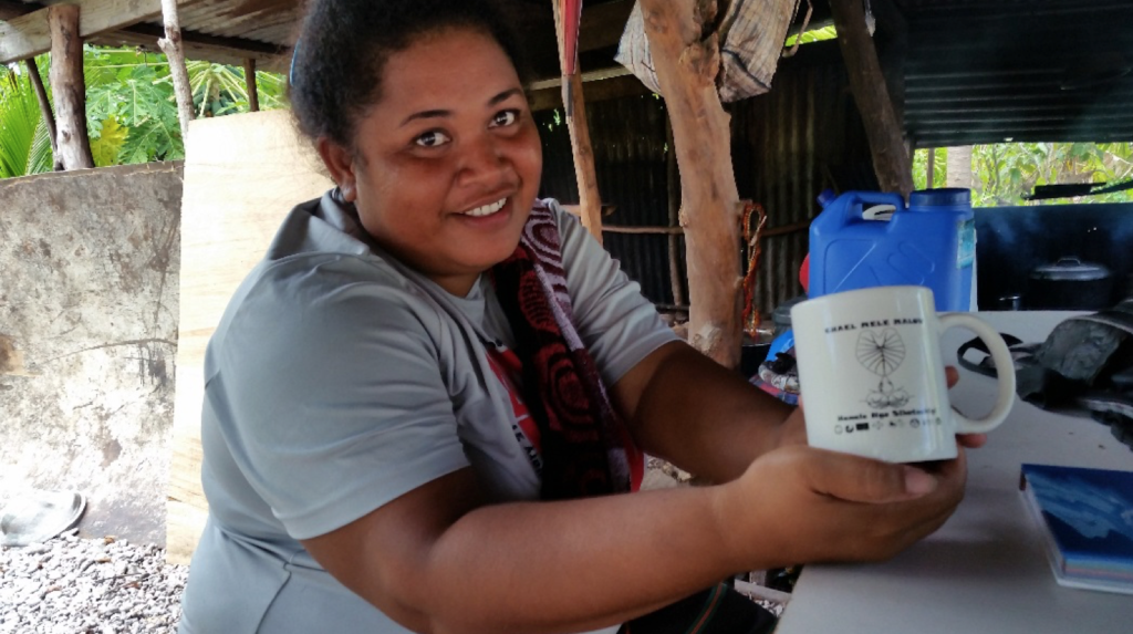 Tina holding a promotional mug urging water conservation